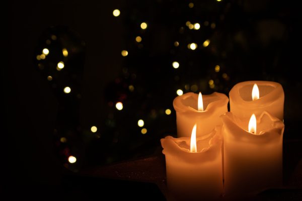 burning candle on black background